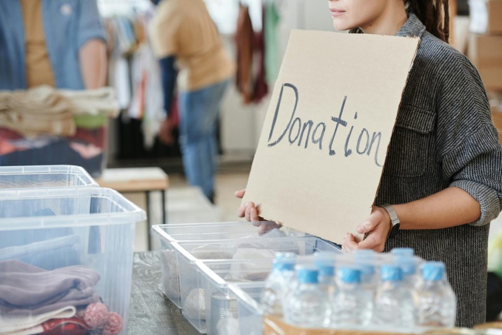 Charity holding a donation sign