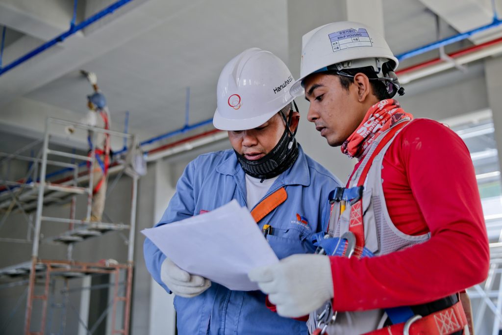 Two engineers looking at plan