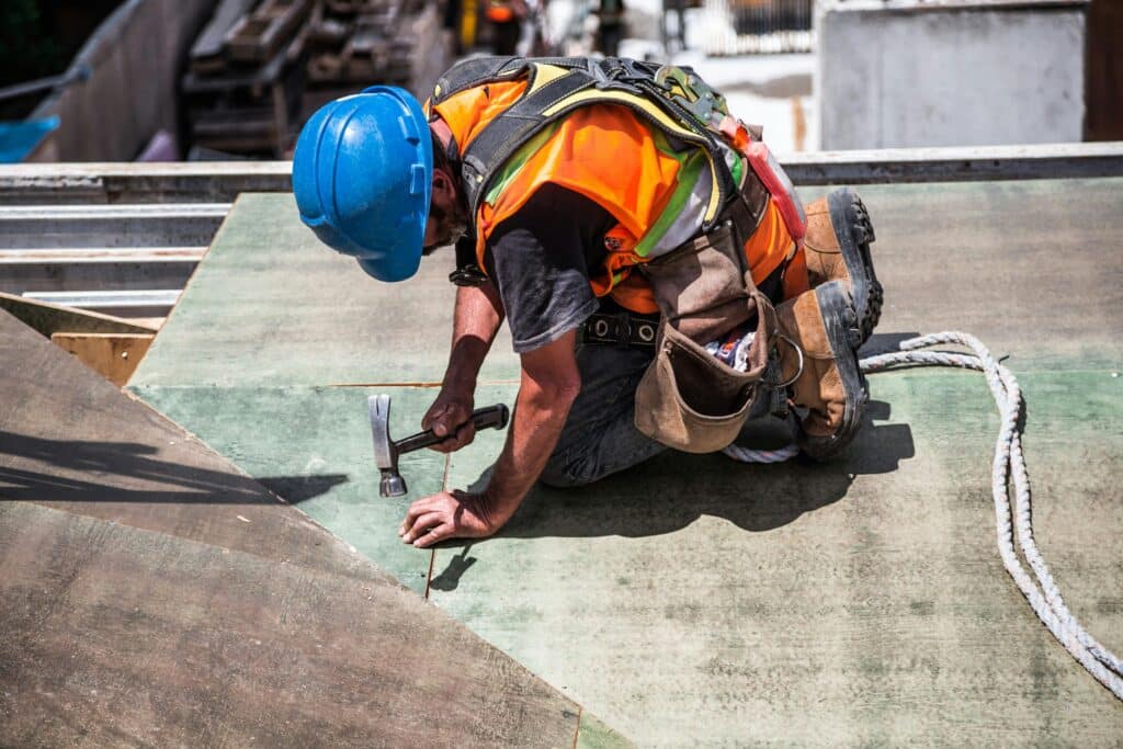 Groundworker Wearing Blue Hard Hat Using Hammer